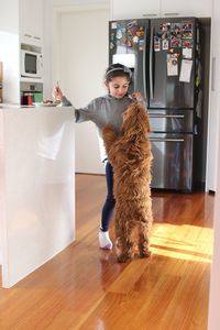 Full length portrait of young woman at home