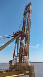 Low angle view of crane against clear sky