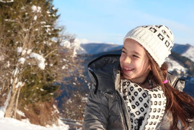 Portrait of smiling woman in snow