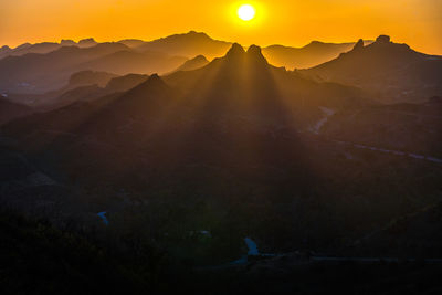 Scenic view of mountains against sky during sunset