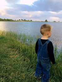 Woman standing by pond