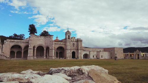 Historic building against cloudy sky