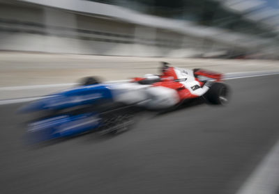 Blurred motion of person riding motorcycle