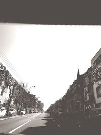 Street amidst buildings against clear sky