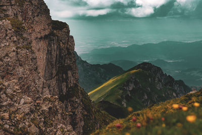 Scenic view of sea and mountains against sky