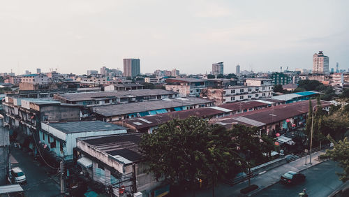 High angle view of street amidst buildings against sky