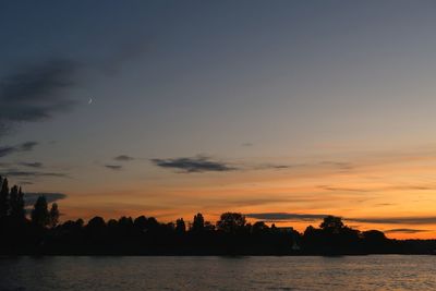 Scenic view of lake against orange sky