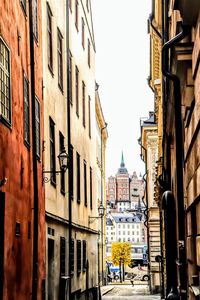 Street amidst buildings in city against sky