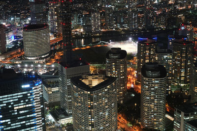 High angle view of city lit up at night