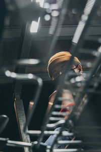 Low angle view of man wearing mask working in factory