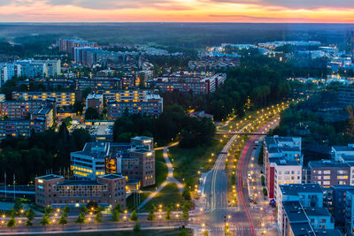 High angle view of illuminated buildings in city at dusk