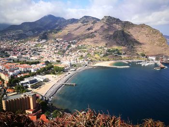 High angle view of townscape by sea