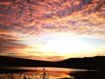 Scenic view of lake against orange sky