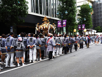 Rear view of people on street in city