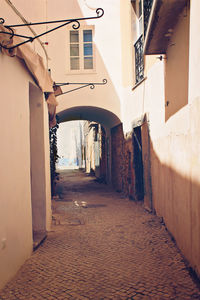 Footpath amidst buildings in city
