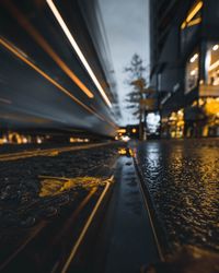 Illuminated bridge over road in city at night