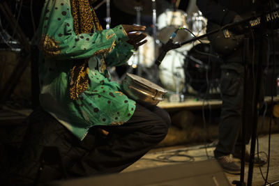 African plays drum. reggae band performance. playing there. details of performance on stage. 