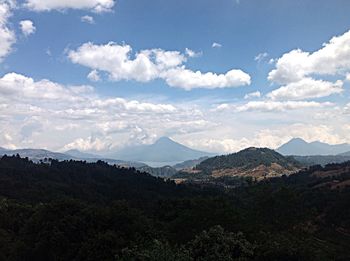 Scenic view of mountains against cloudy sky