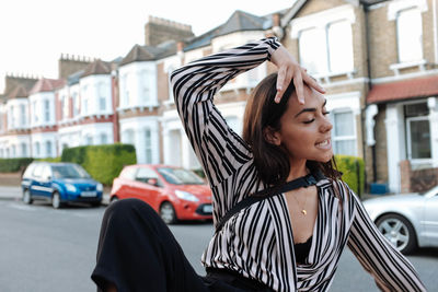 Young woman in car on street in city