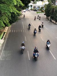 High angle view of people riding motor scooter on road