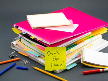 High angle view of text on adhesive note by books on table