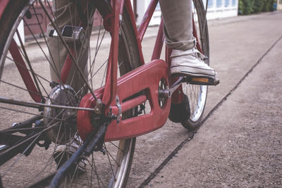 Low section of man with bicycle on road