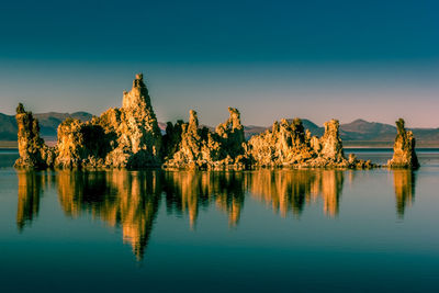 Scenic view of lake against clear blue sky