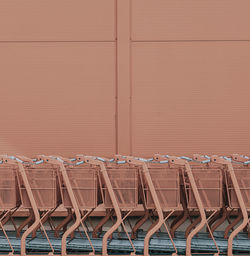 Close-up of shopping carts against wall