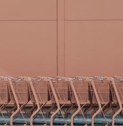 Empty chairs and tables against wall