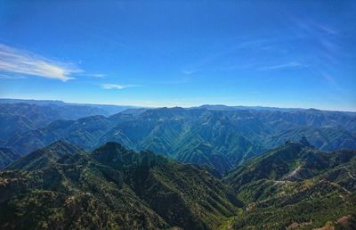 High angle view of mountains against blue sky