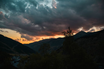 Scenic view of mountains against cloudy sky