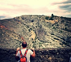 View of rocks against cloudy sky