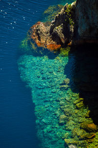 High angle view of rocks in sea