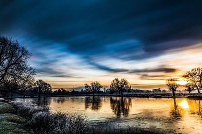 Scenic view of lake against sky during sunset