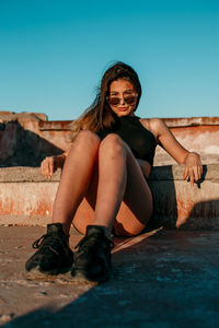 Young woman on terrace against clear sky