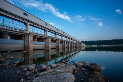 Bridge over lake against blue sky