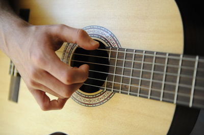Close-up of man playing guitar