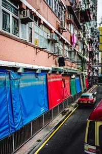 Multi colored buildings by street in city