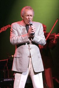 Full length of man holding umbrella standing outdoors