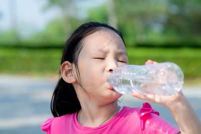 Portrait of a girl drinking water