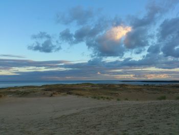 Scenic view of sea against cloudy sky