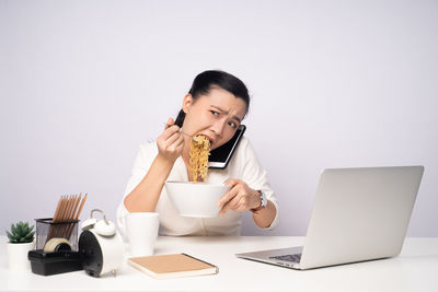 Young woman using laptop on table