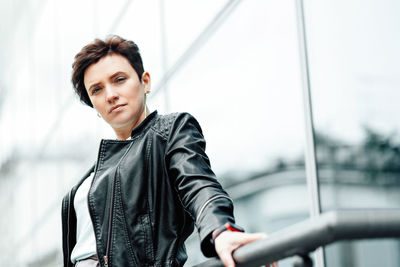 Young woman standing against sky