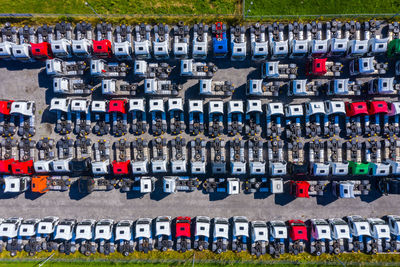 Lots of freight trailers. cars are in several rows. truck parking. aerial view vertically down.