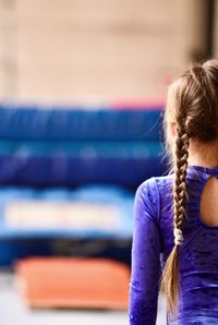 Cropped image of girl wearing gymnastics clothing