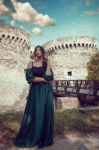 Full length of woman standing against built structure