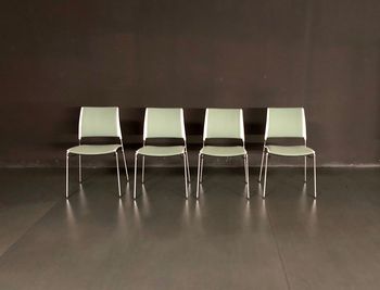 Empty chairs against wall