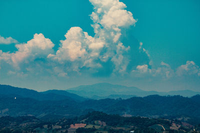 Scenic view of mountains against blue sky