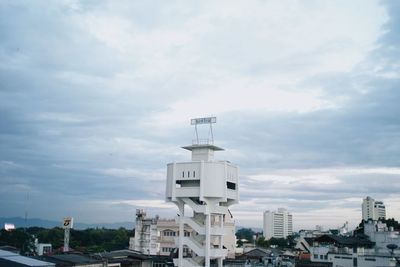 Low angle view of buildings against cloudy sky