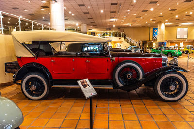 Vintage car parked on illuminated floor in city